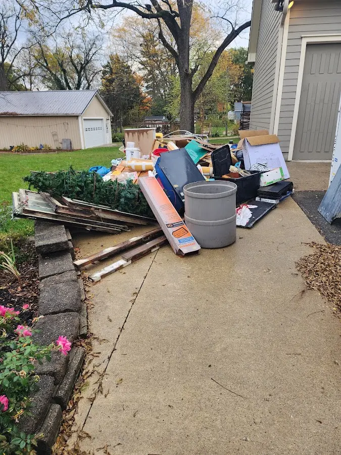 Dumpster being loaded with debris for Estate Cleanout Dumpster Rental in Verona